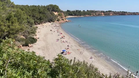 Panoramic view on people relaxing at the Cap Roig beach in Spain 動画素材 240501627