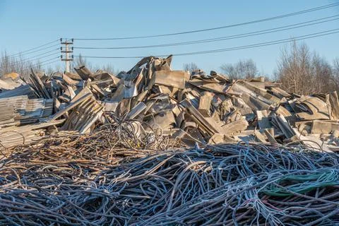 Panoramic view of a pile of rusty scrap metal at a landfill for recycling. Photos