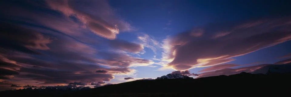 Panoramic view of pink clouds in dramatic sky over Mt Fitzroy, Patagonia Stock Photos