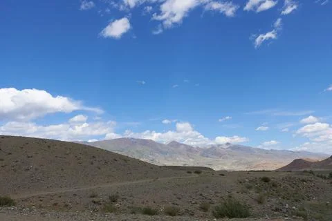 Panoramic view of the plain in the mountains, in variable weather. 스톡 사진