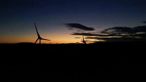 Panoramic view of a power generating wind farm during sunset Stock Footage 220117254