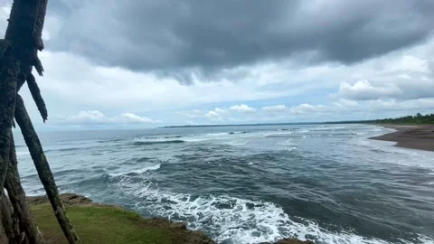 Panoramic View of Powerful Ocean Waves Crashing on a Tropical Coastline Stock Footage 340897376