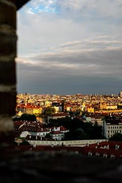 A panoramic view of Prague's skyline at sunset from a historic tower overlooking Stock Photos