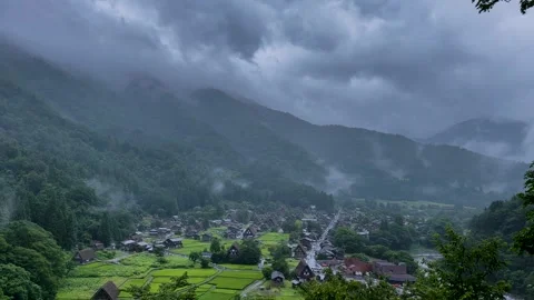 Panoramic View of Rainy Shirakawa-go with Misty Mountains and Rice Fields Stock Footage 338187485