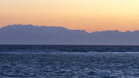 Panoramic View of Red Sea at Dawn with Silhouetted Mountain Range on the Horizon Stock Footage 341909397