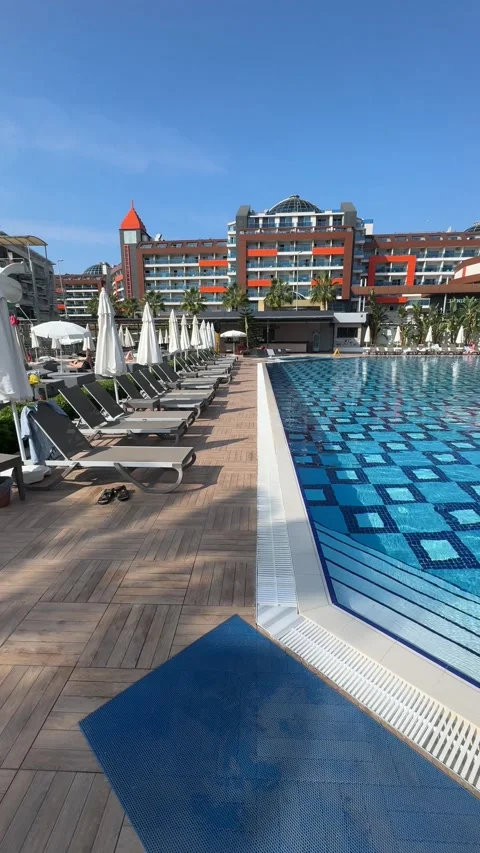 Panoramic view of a resort pool and water park featuring sparkling blue water Stock Footage 321764700