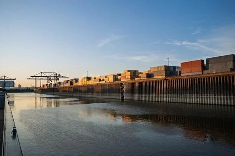 Panoramic view of a river and  dock with containers and cranes Stock Photos