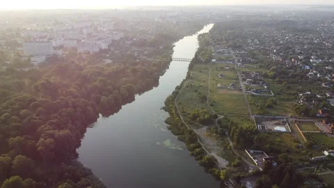 Panoramic view river in city with calm surface, summer morning Aerial drone view Stock Footage 231555778