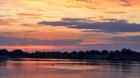 Panoramic view of the river at sunset and cloudy sky Stock Photos