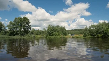 Panoramic view on river water to summer nature and people resting on shore Stock Footage 85596653