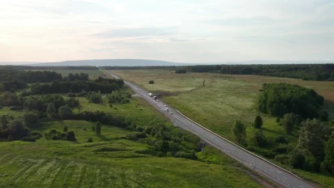 Panoramic view of the road with passing trucks. 스톡 동영상 112857439