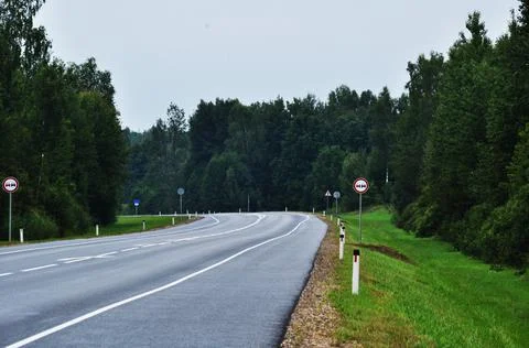 Panoramic view of the road turning through the forest. Stock Photos