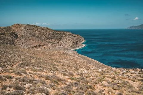 Panoramic view of rocks and beach with sky and clouds in Crete, Greece. Amazing Stock Photos
