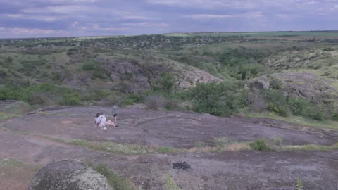 Panoramic view of a rocky canyon and green hills under a dramatic cloudy sky. Stock Footage 337471755