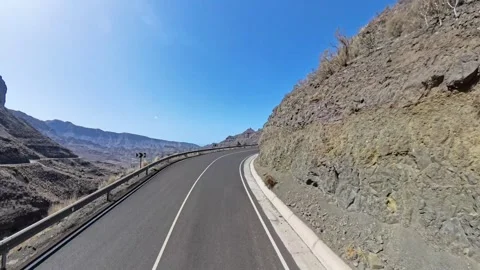 Panoramic view of rocky mountain terrain and the winding GC-200 road. Spain Stock Footage 310051497