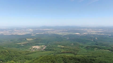 Panoramic View of Rolling Green Hills and Forest Landscape 動画素材 337305188