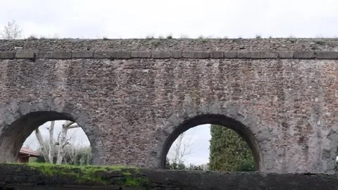 Panoramic view of a Roman aqueduct spanning in the city Stock Footage 316988377