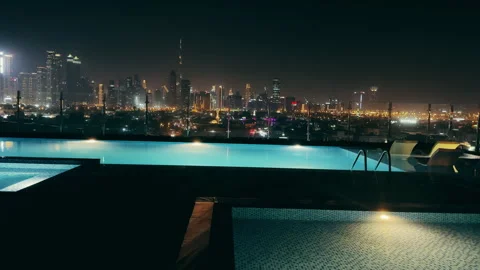 Panoramic view of rooftop infinity pool overlooking Dubai downtown skyline at Stock Footage 315795453