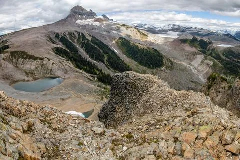 Panoramic view of rugged mountain terrain with glacial lakes and snow-cappe.. Stock-Fotos
