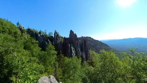 Panoramic view of rugged rock formations and dense forest in Taganay National Pa Stock Footage 325353269