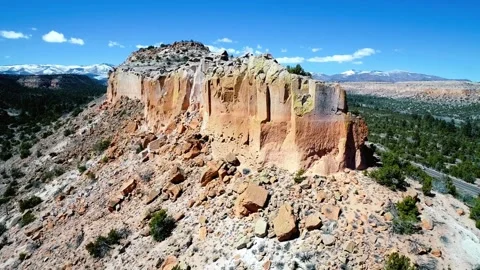 Panoramic View of a Rugged, Sandstone Rock Formation under a Blue Sky Stock Footage 311652872