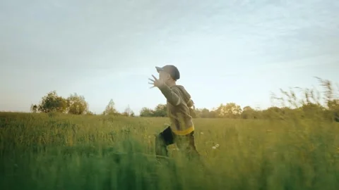 Panoramic view of a running child with arms raised like an airplane. Stock Footage 243120763
