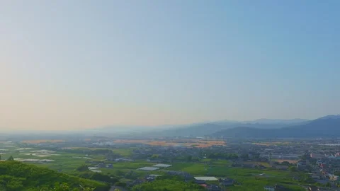 Panoramic view of the rural Chikugo Plains and lush green mountains in Ukiha Vídeos de archivo 335257065