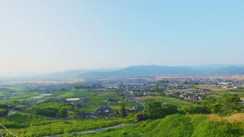 Panoramic view of the rural Chikugo Plains and lush green mountains in Ukiha Stock Footage 335257068