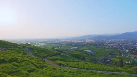 Panoramic view of the rural Chikugo Plains and lush green mountains in Ukiha Stock Footage 335257070