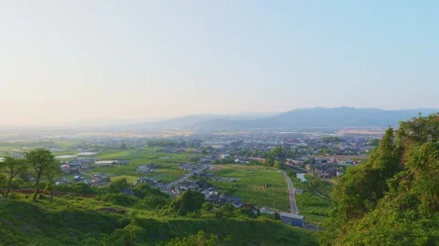 Panoramic view of the rural Chikugo Plains and lush green mountains in Ukiha Stock Footage 335257082