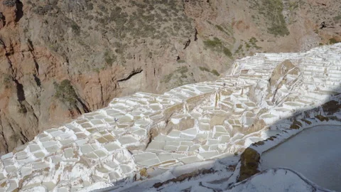 Panoramic view of the salt pans with workers at Salinas de Maras salt mines Stock Footage 202364082