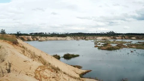 Panoramic view sand quarry. Lake among sandy shores quarry Video stock 79499406