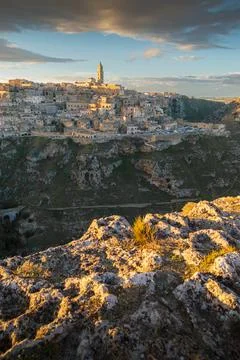 Panoramic view of Sassi of Matera, stone city at sunset, Basilicata, Italy Stock Photos