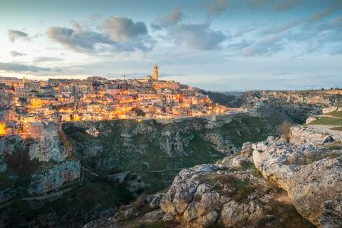 Panoramic view of Sassi of Matera, stone city at sunset, Basilicata, Italy Stock Photos