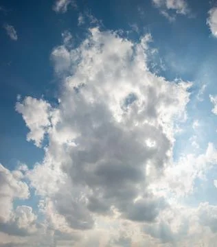 A panoramic view of scattered white clouds against a blue sky Stock Photos