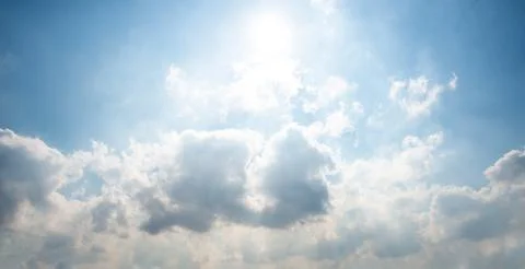 A panoramic view of scattered white clouds against a blue sky Stock Photos