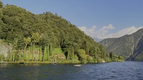 Panoramic view of scenic Lake Como shoreline in Italy filmed from moving boat Stock Footage 320799268
