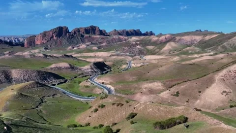 Panoramic View of Scenic Road Winding Through Arid Mountains Xinjiang China Stock Footage 346586196
