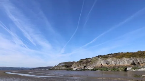Panoramic View of Sea Rocky Coast at Low Tide With Blue Sky Stock Footage 246939699