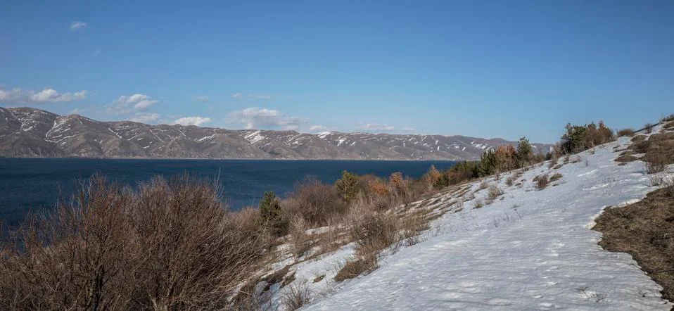 Panoramic view of Sevan Lake with snow maintains around of it Stock Photos