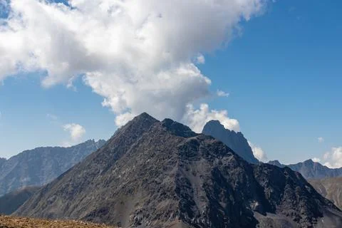 A panoramic view on the sharp mountain peaks of the Chaukhi massif in the G.. Stock Photos