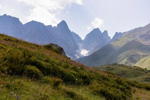 A panoramic view on the sharp mountain peaks of the Chaukhi massif in the G.. Stock Photos