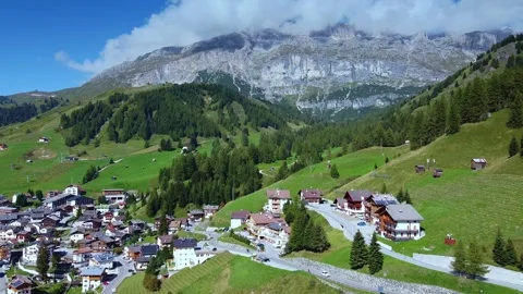 Panoramic view showcasing alpine village nestled in mountainous valley Video stock 342339409