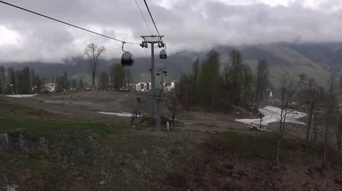Panoramic view of ski resort in low season, slide above empty ground field Stock Footage 64239959