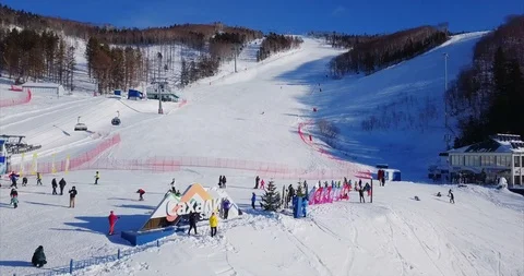 Panoramic view of ski resort slope, ski lift elevator and winter nature. Aerial Stock Footage 88486272