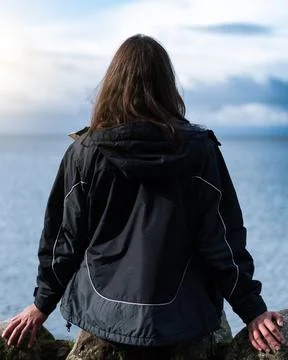 Panoramic view of a sky with clouds and a young woman with her back to the ca Stock Photos