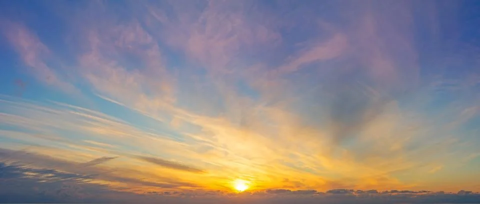 Panoramic view of the sky with different types of clouds gradient illuminated Stock Photos