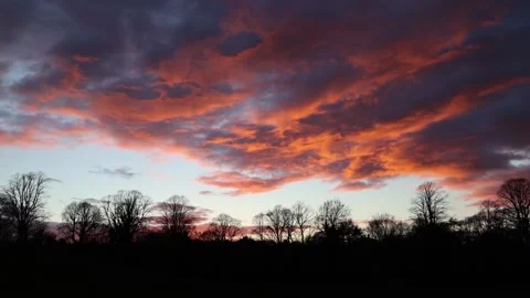 Panoramic View of the Sky With Massive Dark Clouds Sunlit up in Deep Red Stock Footage 246939922