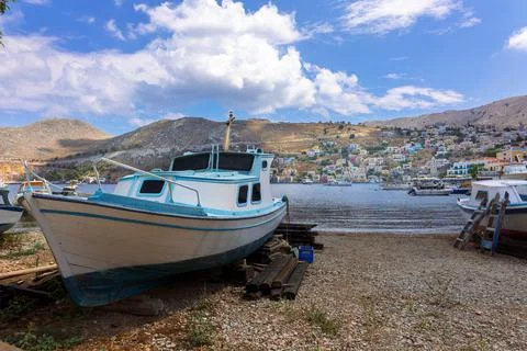Panoramic view of small haven of Symi island. Village with tiny beach, moored Stock Photos