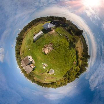 Panoramic view, small planet and blue sky around the globe Stock Photos